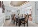 Formal dining room with wainscoting, chandelier, and a large table that's perfect for hosting dinner parties at 4450 Sandalwood Way, Cumming, GA 30041