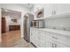 Bright kitchen area with stainless steel appliances, white cabinetry, and marble countertops, providing a clean and modern cooking space at 4450 Sandalwood Way, Cumming, GA 30041