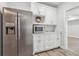 Kitchen featuring stainless steel refrigerator, white cabinets and marble countertops, and microwave perfect for everyday meals at 4450 Sandalwood Way, Cumming, GA 30041