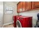 Bright laundry room with upper cabinets and a modern washer and dryer at 4450 Sandalwood Way, Cumming, GA 30041