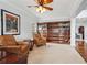 Inviting living room features a large built-in bookshelf and comfortable leather armchairs at 4450 Sandalwood Way, Cumming, GA 30041