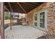 Covered outdoor patio with stone accents, a built-in grill, and ample space for outdoor dining and relaxation at 4450 Sandalwood Way, Cumming, GA 30041