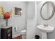 This powder room features a pedestal sink, decorative mirror, and stylish vanity at 4450 Sandalwood Way, Cumming, GA 30041