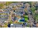 Aerial view of the townhome community with mature trees and landscaping around the community pool at 11 Newport Nw Pl, Atlanta, GA 30318