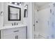 Stylishly updated bathroom with a modern vanity, framed mirror and a tiled tub and shower at 11 Newport Nw Pl, Atlanta, GA 30318