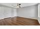 Bright bedroom featuring wood floors, a ceiling fan, and double-door closets at 11 Newport Nw Pl, Atlanta, GA 30318