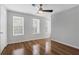 Bedroom with ceiling fan, hardwood floors, and natural light from three windows at 11 Newport Nw Pl, Atlanta, GA 30318