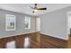 Spacious bedroom with three windows providing natural light, ceiling fan, and vinyl flooring at 11 Newport Nw Pl, Atlanta, GA 30318