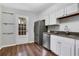 Bright kitchen with stainless steel refrigerator, a glass panelled back door and wood-look vinyl floors at 11 Newport Nw Pl, Atlanta, GA 30318