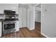 Kitchen view featuring stainless steel oven, pantry doors, vinyl floors and view to living room at 11 Newport Nw Pl, Atlanta, GA 30318