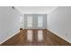 Living room with wood flooring, neutral paint and white trim at 11 Newport Nw Pl, Atlanta, GA 30318