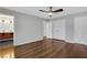 Spacious main bedroom with a ceiling fan, beautiful floors, and a view of the bathroom at 11 Newport Nw Pl, Atlanta, GA 30318