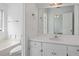 Bathroom vanity featuring a mirror, a sink and white cabinets below at 110 Oak Wood Ln, Covington, GA 30016