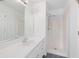 Bathroom vanity featuring a mirror, a sink and a glass-doored shower stall at 110 Oak Wood Ln, Covington, GA 30016