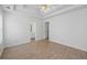 Bright bedroom featuring a trey ceiling, ceiling fan and wood-look floors at 110 Oak Wood Ln, Covington, GA 30016