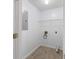 Small laundry room featuring white walls, minimal layout, and vinyl flooring at 110 Oak Wood Ln, Covington, GA 30016