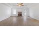 Open living room featuring a fireplace, modern ceiling fan, and neutral paint at 110 Oak Wood Ln, Covington, GA 30016