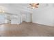 Bright living room featuring wood-look flooring and an open-concept layout to the kitchen and a tray ceiling with fan at 110 Oak Wood Ln, Covington, GA 30016