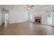 Spacious living room featuring a fireplace, wood-look flooring, and ample natural light at 110 Oak Wood Ln, Covington, GA 30016