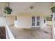 Covered porch featuring hanging flower baskets, white rails, and neutral siding at 110 Oak Wood Ln, Covington, GA 30016