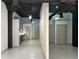 Modern living room with painted ceilings, industrial ductwork, and view into the stainless kitchen at 172 Haynes Sw St # 102, Atlanta, GA 30313