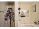 Well-lit bathroom with a soaking tub, vanity, and decorative accents at 2096 Old Jackson Rd, Locust Grove, GA 30248