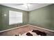 A minimalist bedroom with neutral green wall and a decorative cow-print rug at 2096 Old Jackson Rd, Locust Grove, GA 30248