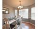 Bright dining room with modern lighting, a window view, and neutral decor for elegant meals at 2096 Old Jackson Rd, Locust Grove, GA 30248