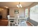 Cozy dining area features wood floors, a stylish chandelier, and natural light from the large window at 2096 Old Jackson Rd, Locust Grove, GA 30248