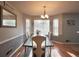 Inviting dining room with wainscoting, a modern chandelier, and large windows for lots of light at 2096 Old Jackson Rd, Locust Grove, GA 30248