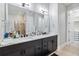 Bathroom featuring double sinks, white countertops, and dark cabinetry at 2300 Peachford Rd # 1410, Atlanta, GA 30338