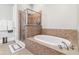 Luxurious bathroom with a glass enclosed shower and an oval soaking tub at 2300 Peachford Rd # 1410, Atlanta, GA 30338