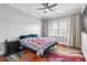 A cozy bedroom featuring hardwood floors, a ceiling fan, and a neutral color palette at 2300 Peachford Rd # 1410, Atlanta, GA 30338