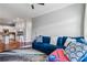 Bright living room with a comfortable blue couch and hardwood floors connected to kitchen at 2300 Peachford Rd # 1410, Atlanta, GA 30338