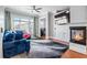 Comfortable living room with a fireplace, ceiling fan, and hardwood floors at 2300 Peachford Rd # 1410, Atlanta, GA 30338