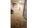 Well-lit hallway features plush carpet and neutral paint, creating a welcoming atmosphere at 11700 Brightside Pkwy, Hampton, GA 30228
