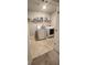 Clean and functional laundry room features a washer, dryer, and shelving for storage at 11700 Brightside Pkwy, Hampton, GA 30228