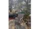 Backyard area featuring mature trees and a chair at 502 Turner Ave, Palmetto, GA 30268