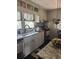 Well-lit kitchen with white cabinets, stylish backsplash, stainless steel appliances, and a modern sink at 502 Turner Ave, Palmetto, GA 30268