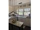 Bright kitchen featuring white cabinets, a granite countertop island, and a sink with natural light at 502 Turner Ave, Palmetto, GA 30268