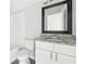 Bathroom features a granite countertop vanity, bathtub and a black framed mirror at 5368 Stafford Nw Dr, Lilburn, GA 30047