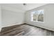 Bedroom features new gray floors, neutral walls and a bright window at 5368 Stafford Nw Dr, Lilburn, GA 30047
