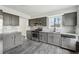 Beautiful kitchen with grey cabinets, stainless steel appliances and large windows at 5368 Stafford Nw Dr, Lilburn, GA 30047