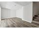 Spacious living room featuring light gray walls and wood flooring next to stairs at 5368 Stafford Nw Dr, Lilburn, GA 30047