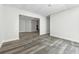 Living room featuring gray wood flooring leading into a large doorway with stairs at 5368 Stafford Nw Dr, Lilburn, GA 30047