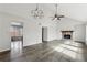 Open living room featuring vaulted ceilings, a stone fireplace, and hardwood floors at 5368 Stafford Nw Dr, Lilburn, GA 30047