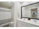 Modern bathroom with double vanity and a framed mirror at 938 Blue Juniper Cir, Loganville, GA 30052