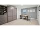 Bedroom with grey accent wall, a Murphy bed and a work desk in front of the window at 938 Blue Juniper Cir, Loganville, GA 30052