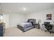 Bedroom with a tufted headboard bed and carpet floor at 938 Blue Juniper Cir, Loganville, GA 30052