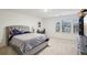 Spacious bedroom with large bed, natural light from the windows, and organized shelving at 938 Blue Juniper Cir, Loganville, GA 30052